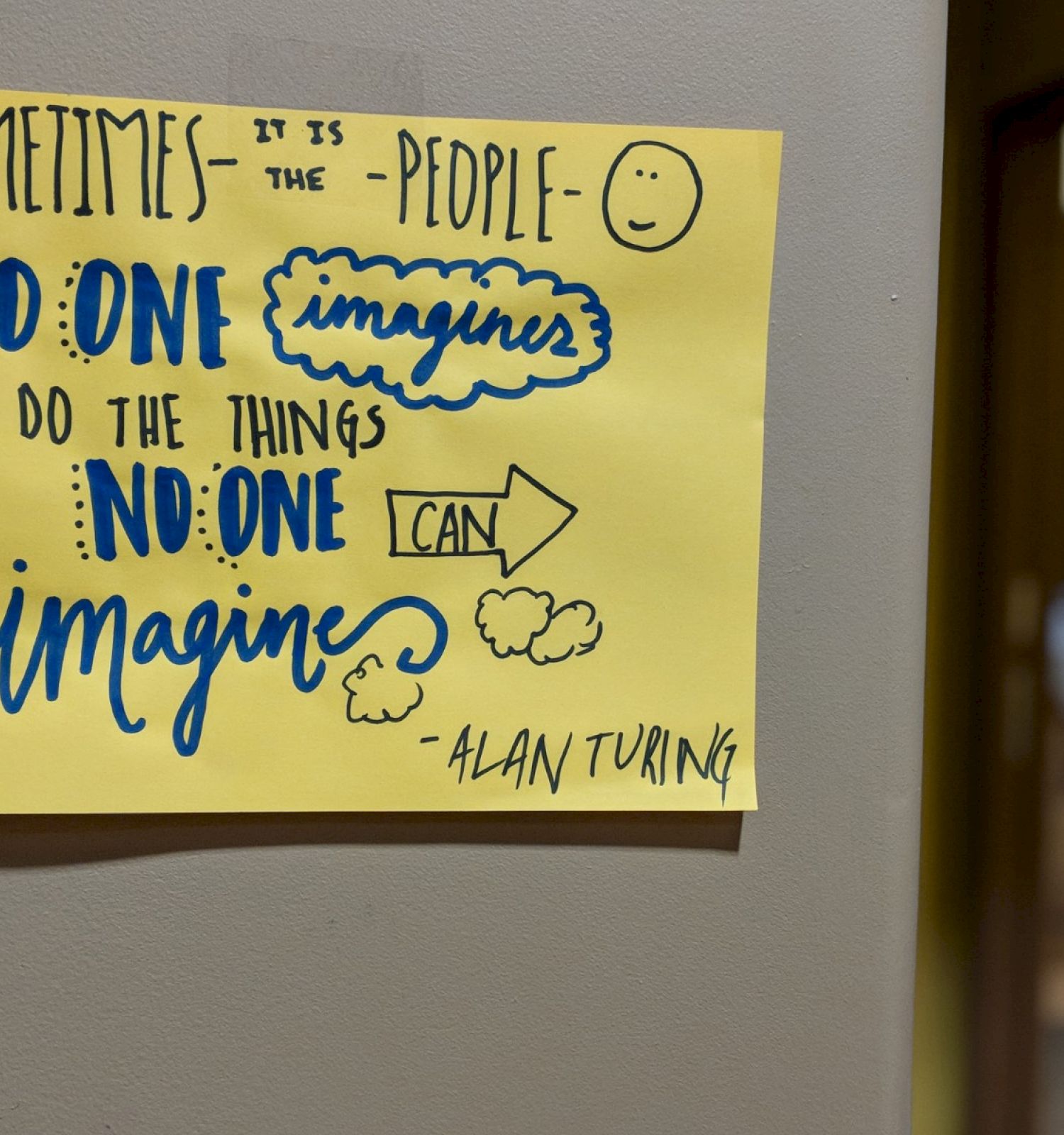 A quote by Alan Turing on a yellow poster reads: 