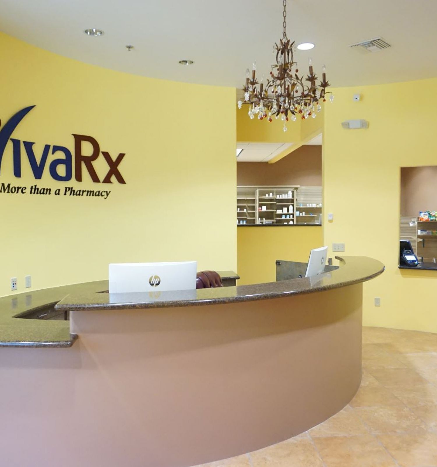 A pharmacy reception area with a sign 